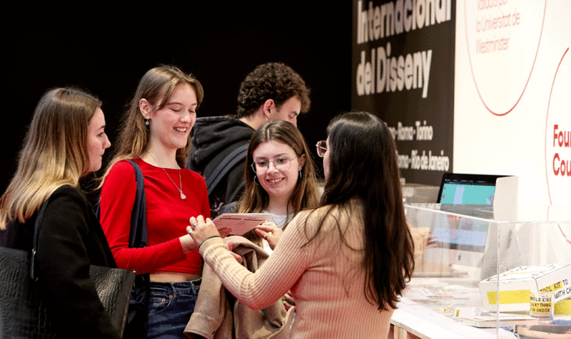 Young people asking about the training offer in design at the IED Barcelona stand at the Saló de l'Ensenyament 2024