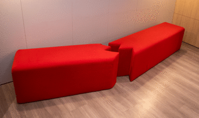 Red bench with a crack to raise awareness about gender violence designed by IED Barcelona for the Consulate General of Italy in Barcelona